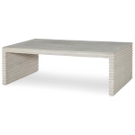 The Belmont Coffee Table in White Rustic Pine sits in a studio.