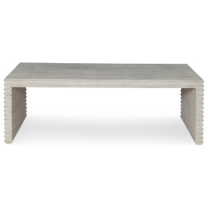 The Belmont Coffee Table in White Rustic Pine sits in a studio.