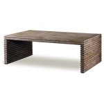 The Belmont Coffee Table in Rustic Grey Pine sits in a studio.