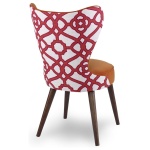 The Maribella Chair in Marmalade Velvet with Custom COM back sits in a studio.
