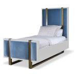 The Mercer Bed, Twin in White Smooth Gesso and Harbour Velvet sits in a studio.