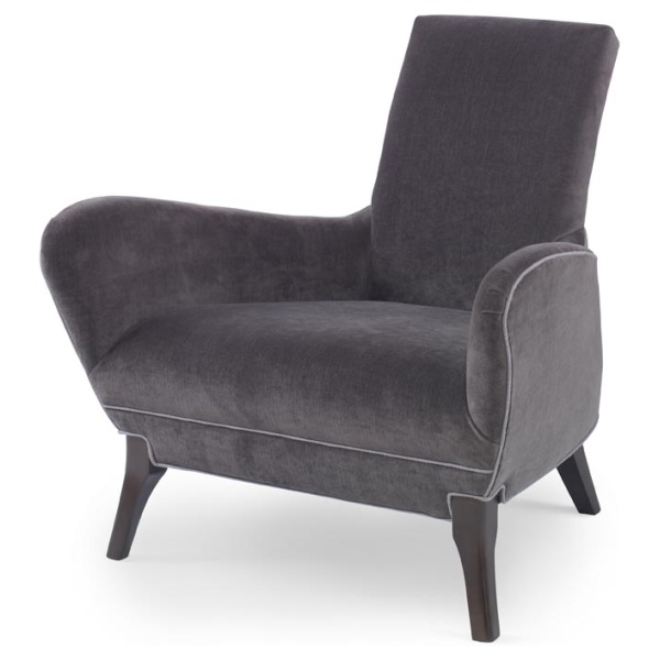 The Naomi Chair in Dark Grey Velvet with Dark Maple Finishes sits in a studio.