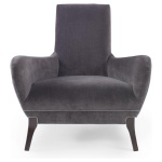 The Naomi Chair in Dark Grey Velvet with Dark Maple Finishes sits in a studio.